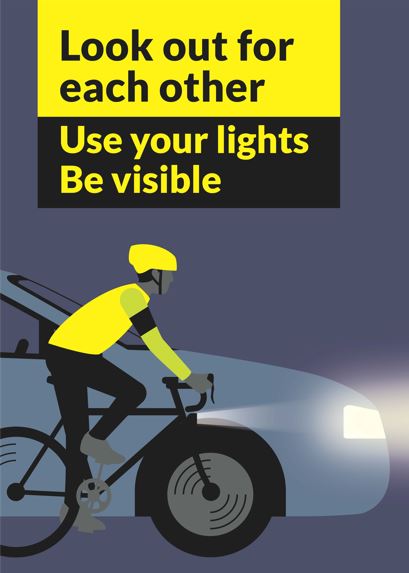 Look out for each other: Cyclist wearing hi vis and with lights passing car with headlights on.